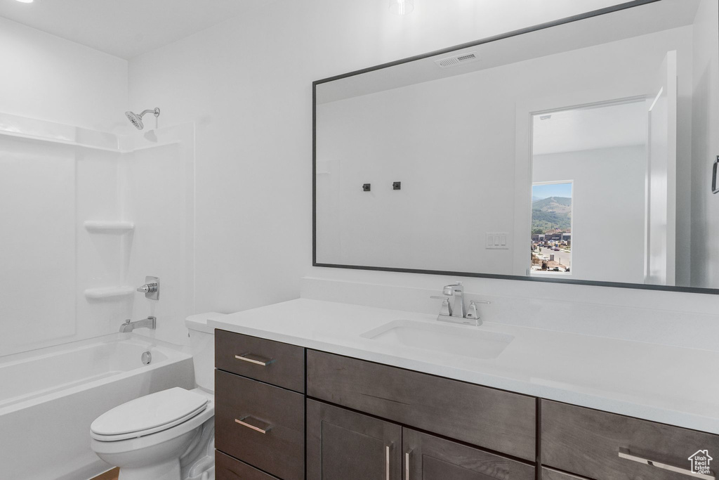 Full bathroom featuring vanity, toilet, and bathing tub / shower combination