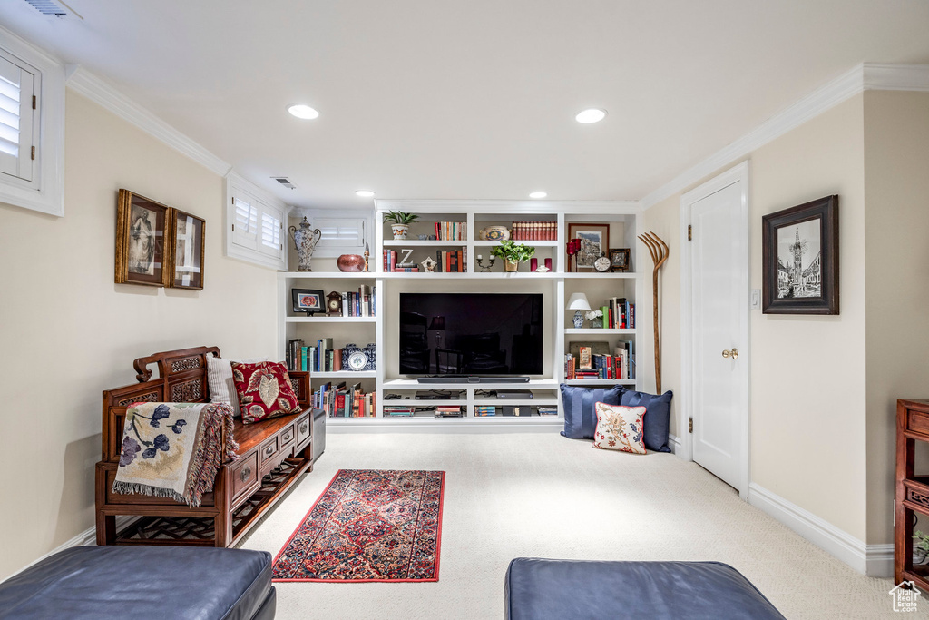 Carpeted living room featuring crown molding