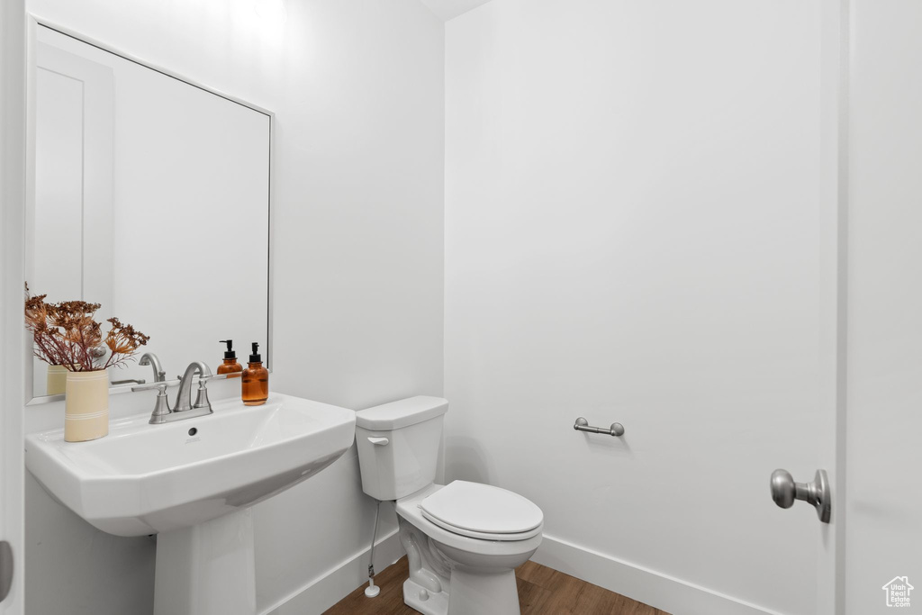 Bathroom with hardwood / wood-style floors and toilet