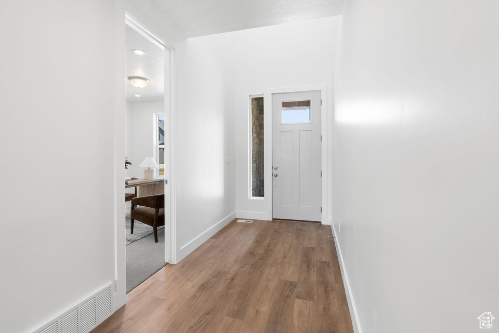 Doorway to outside featuring hardwood / wood-style floors