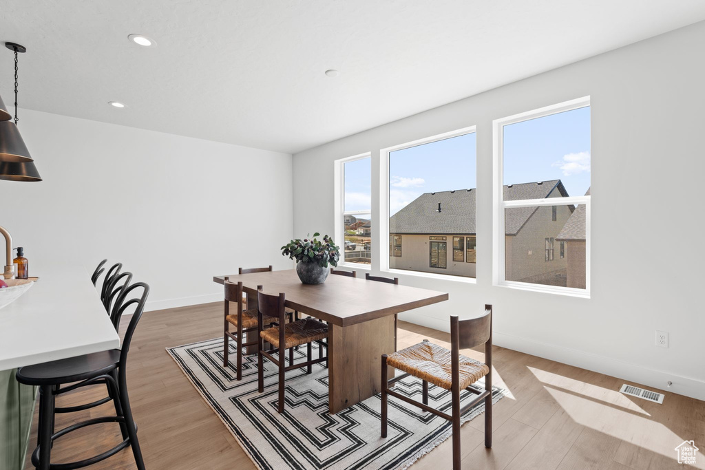 Dining area with light hardwood / wood-style floors