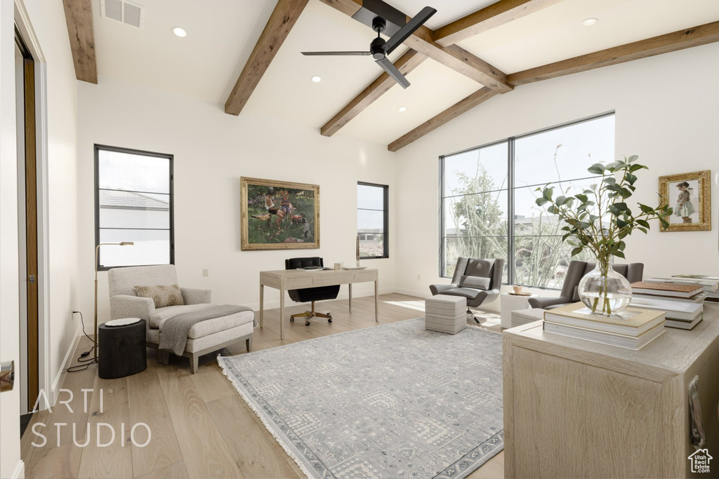 Living room with vaulted ceiling with beams, ceiling fan, and light hardwood / wood-style flooring