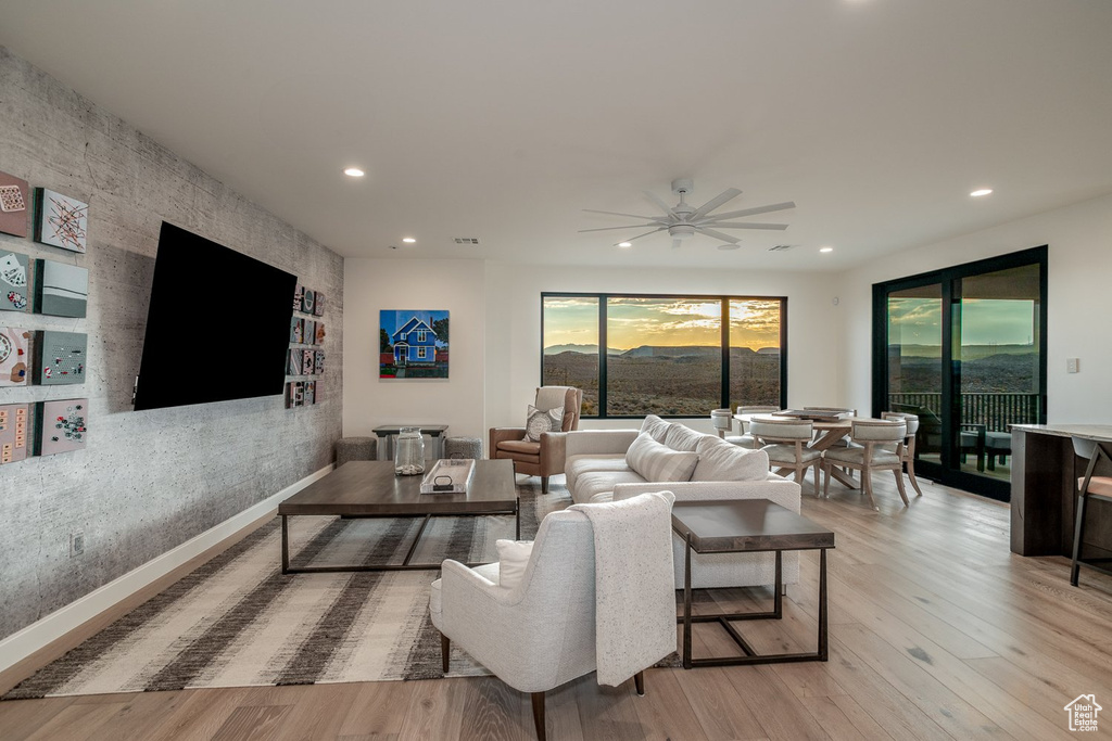 Living room featuring ceiling fan and light wood-type flooring