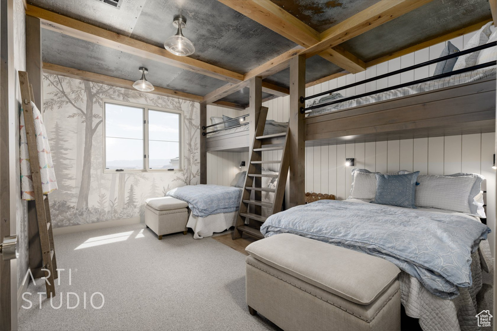 Carpeted bedroom featuring beam ceiling