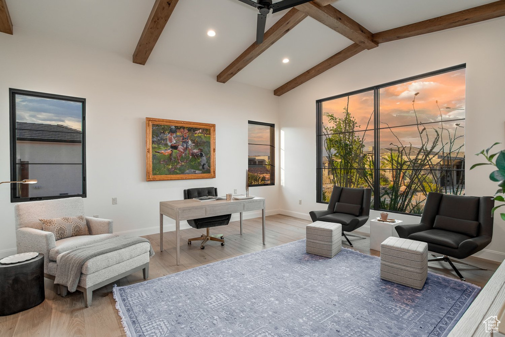 Office space with vaulted ceiling with beams and light wood-type flooring