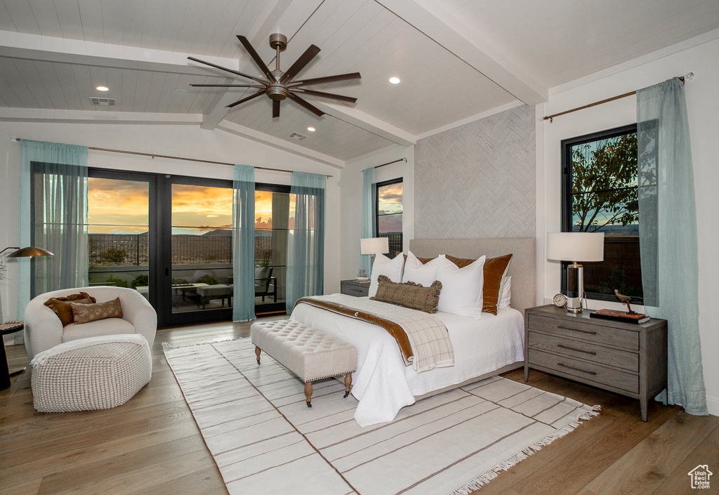 Bedroom featuring access to exterior, wood-type flooring, ceiling fan, and vaulted ceiling with beams