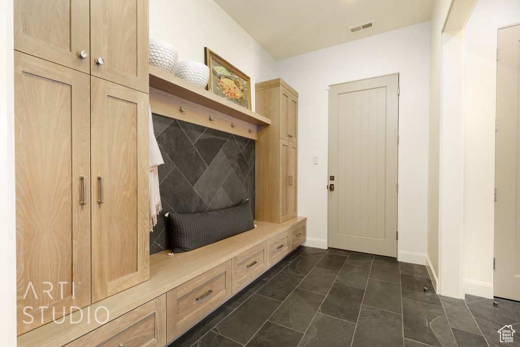 Mudroom with dark tile patterned flooring