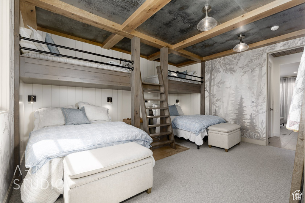 Bedroom featuring beamed ceiling and carpet floors