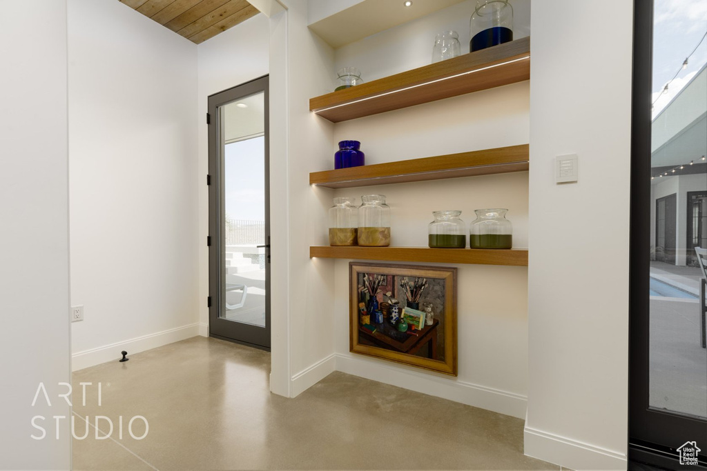 Interior space with wooden ceiling and concrete floors