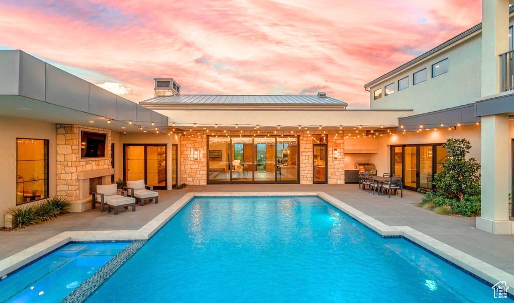 Pool at dusk with a patio area