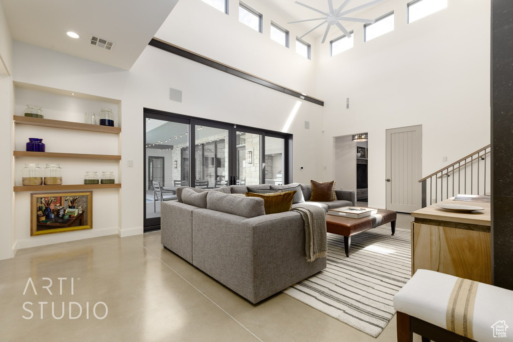 Living room with a healthy amount of sunlight and a high ceiling