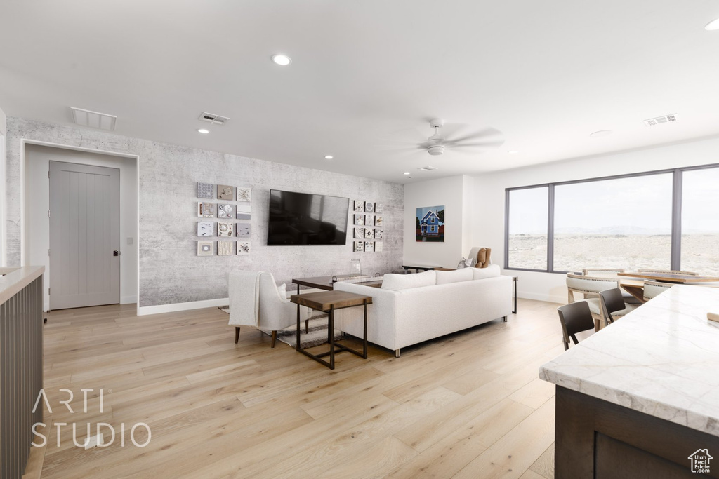 Living room featuring light hardwood / wood-style floors and ceiling fan