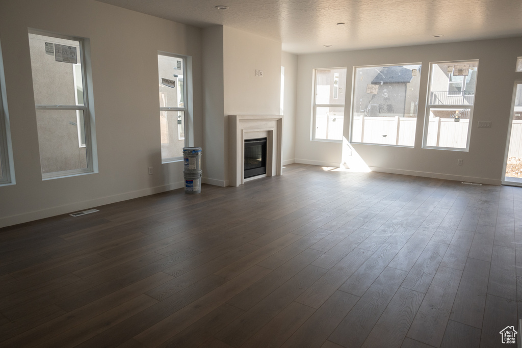 Unfurnished living room with dark hardwood / wood-style flooring