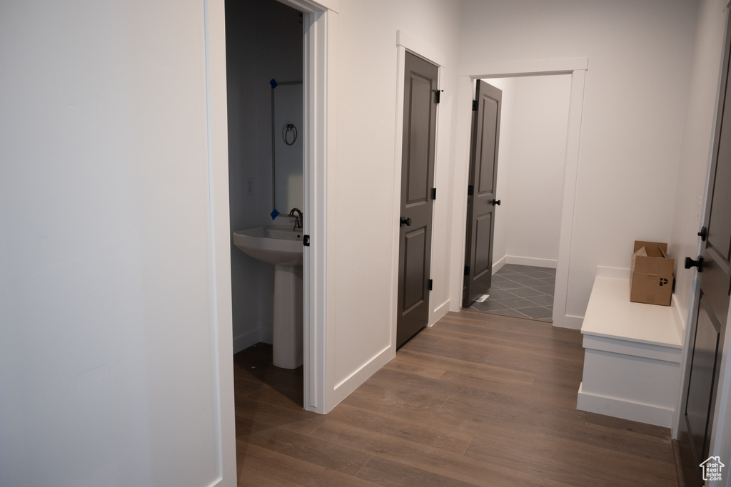 Corridor with sink and dark wood-type flooring