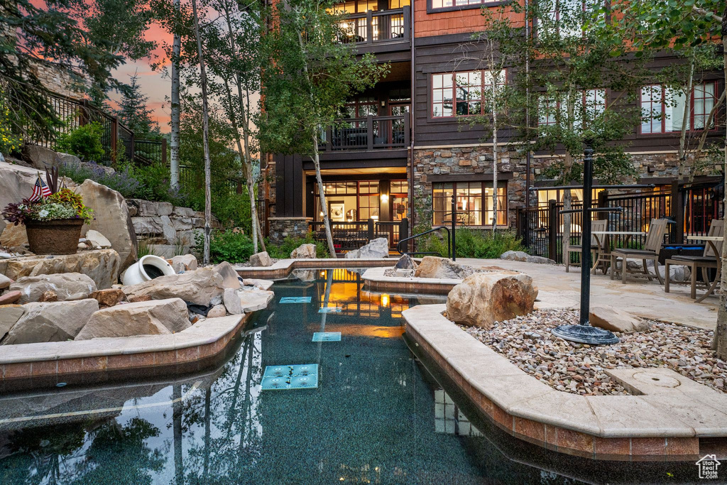 View of pool at dusk