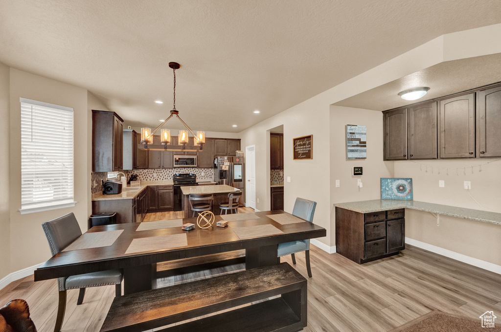 Dining area featuring light hardwood / wood-style flooring and a chandelier