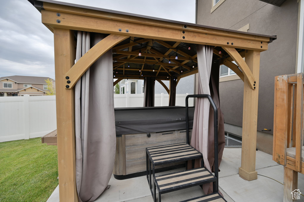 View of patio / terrace featuring a gazebo and a hot tub