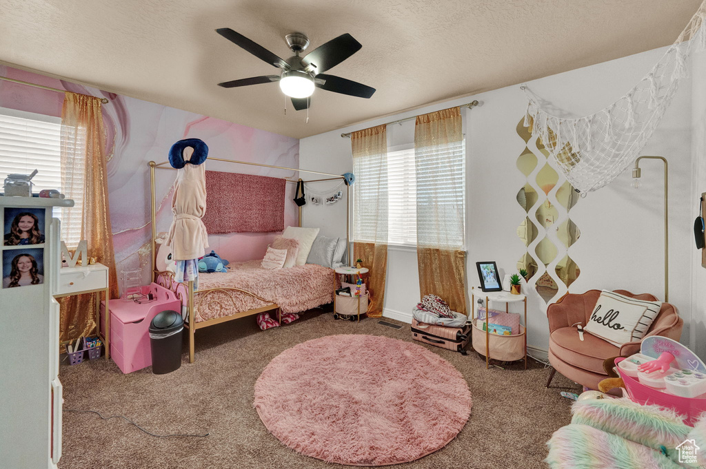 Bedroom with multiple windows, carpet floors, and ceiling fan