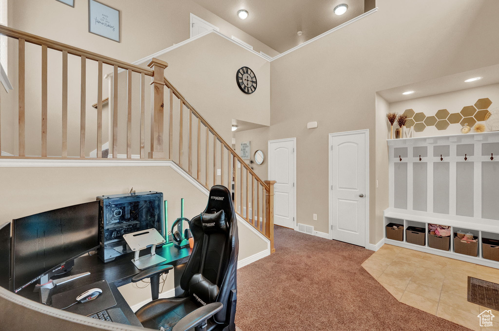 Office featuring a high ceiling and tile patterned floors