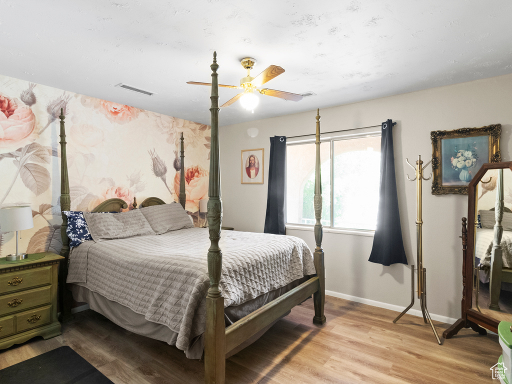 Bedroom featuring ceiling fan and wood-type flooring