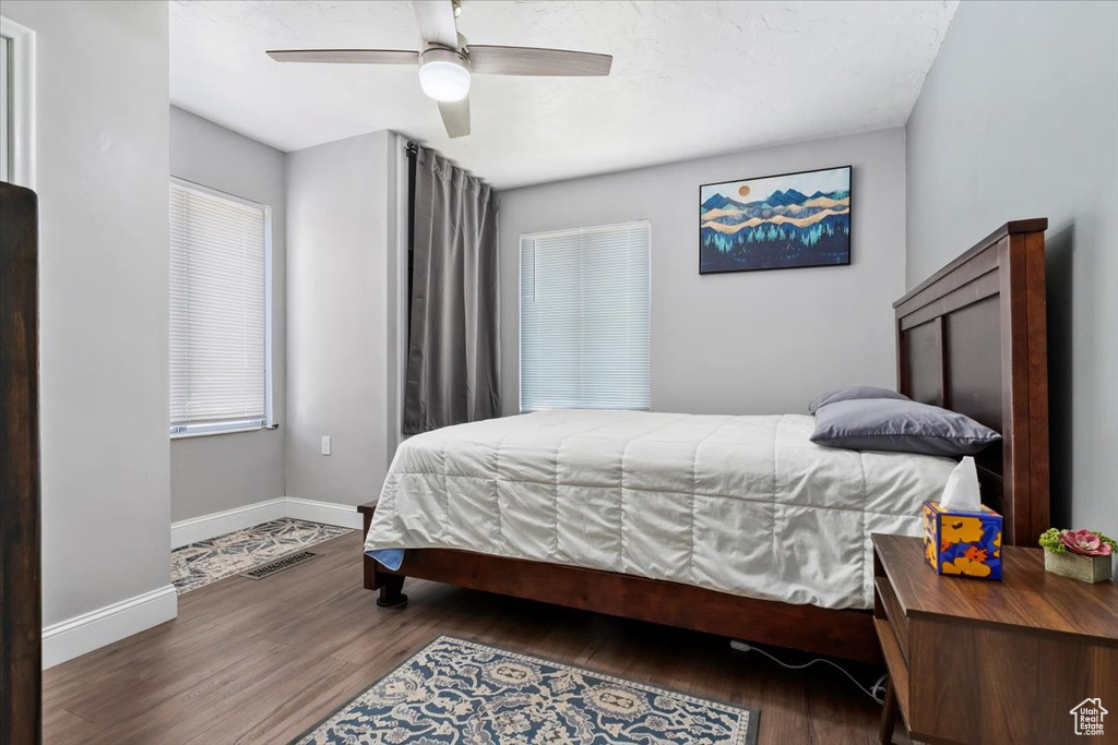 Bedroom featuring ceiling fan and hardwood / wood-style flooring