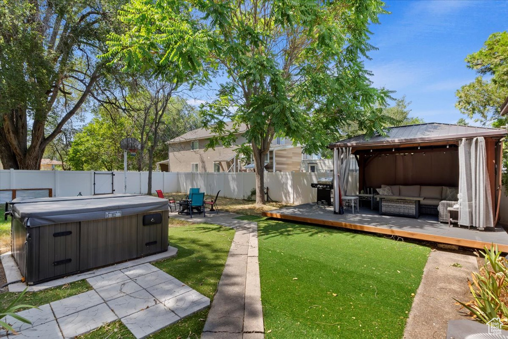 View of yard with a gazebo, a hot tub, and a patio area