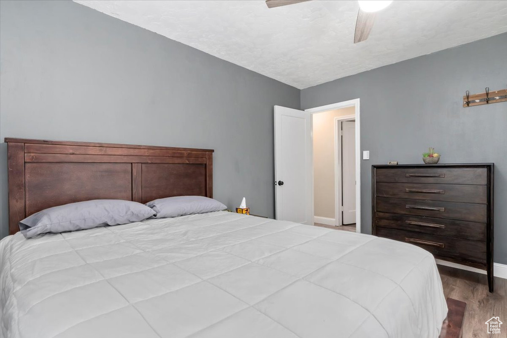 Bedroom with hardwood / wood-style flooring, vaulted ceiling, and ceiling fan