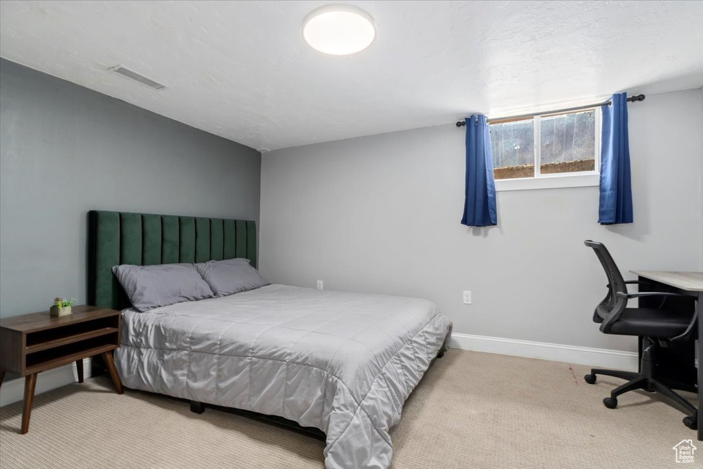 Bedroom with light carpet