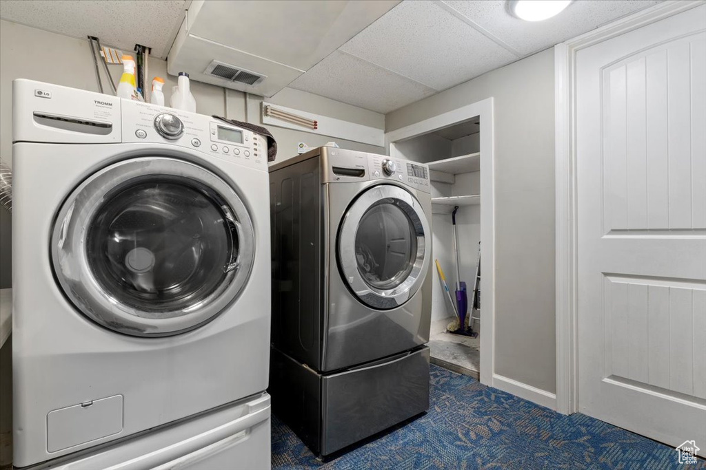 Clothes washing area with washer and dryer and carpet flooring