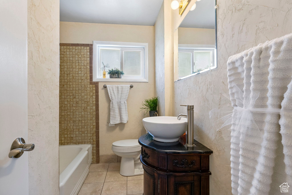 Full bathroom featuring vanity, tile walls, bathing tub / shower combination, toilet, and tile patterned flooring