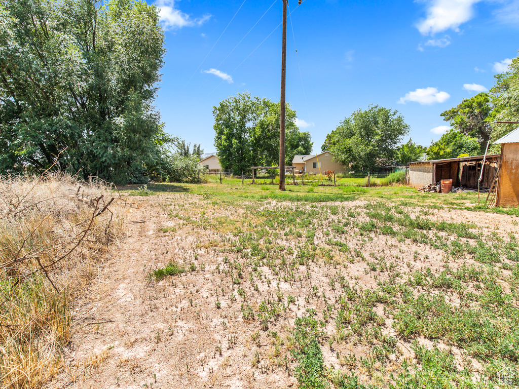 View of yard featuring a rural view and an outdoor structure