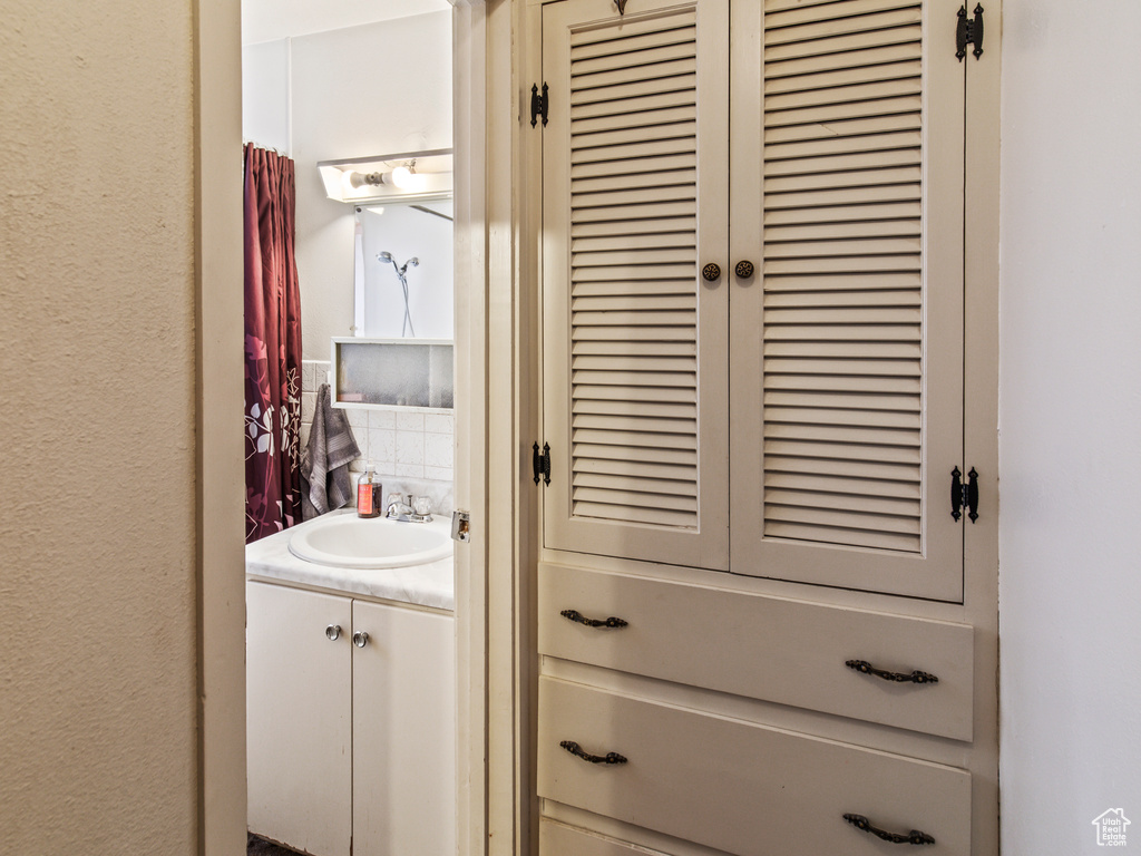 Interior space featuring vanity and backsplash