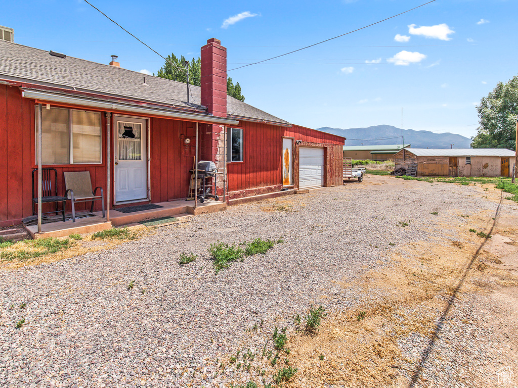 Single story home with a mountain view and a garage