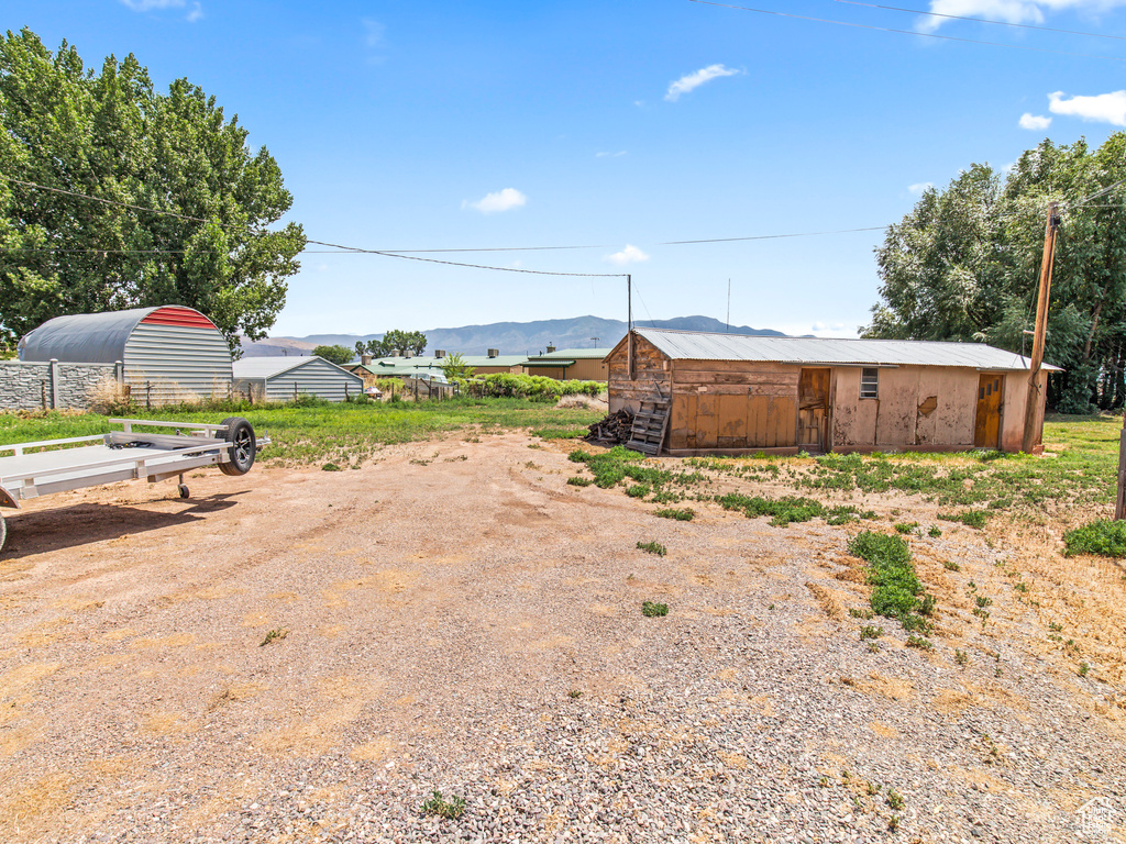 View of yard featuring a mountain view and an outdoor structure