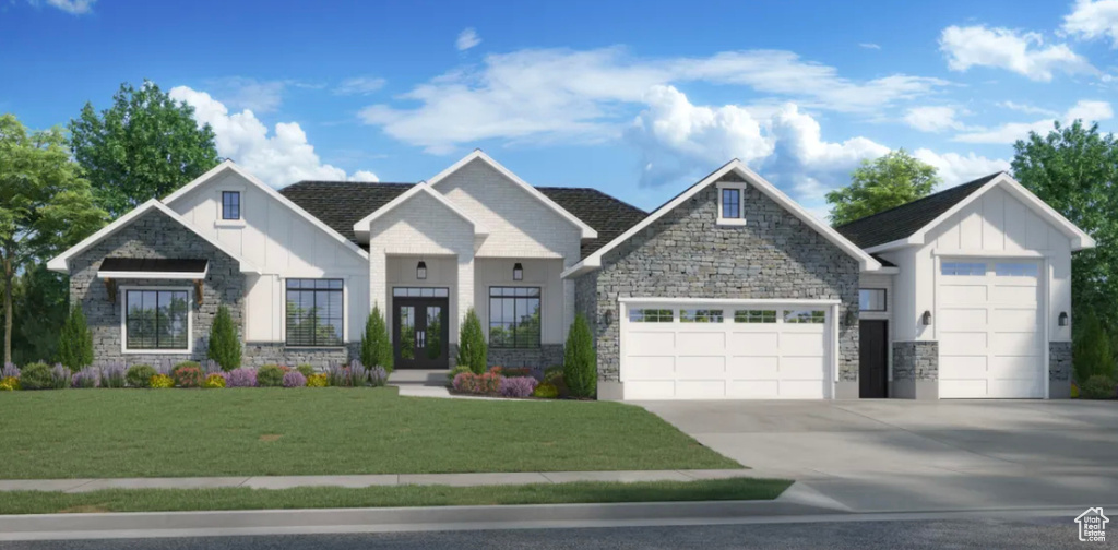 View of front facade featuring a garage and a front yard