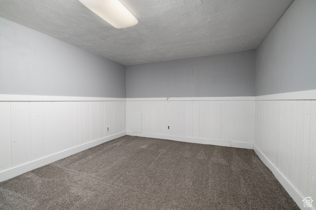 Spare room featuring carpet floors and a textured ceiling