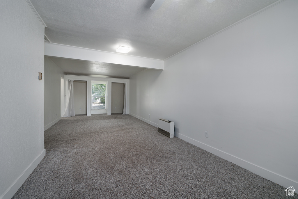 Carpeted spare room featuring a textured ceiling