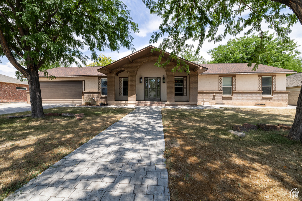 Single story home featuring a porch and a garage