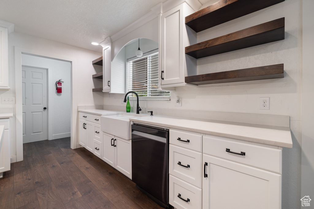 Kitchen with sink, white cabinetry, dishwasher, and dark hardwood / wood-style floors