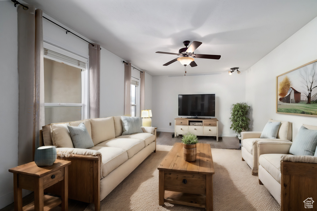 Living room featuring ceiling fan and light colored carpet