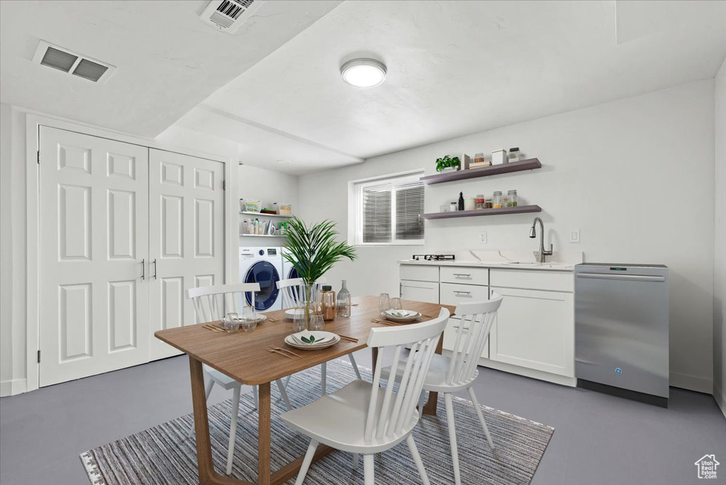 Dining area with concrete floors, sink, and washer / clothes dryer