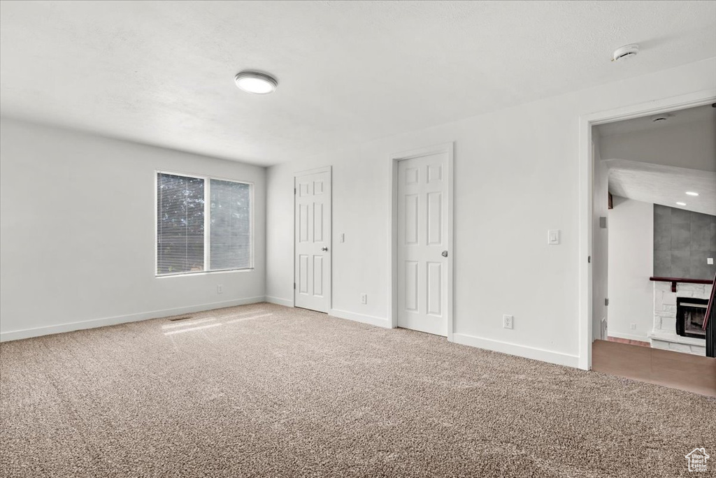 Interior space featuring carpet and a fireplace