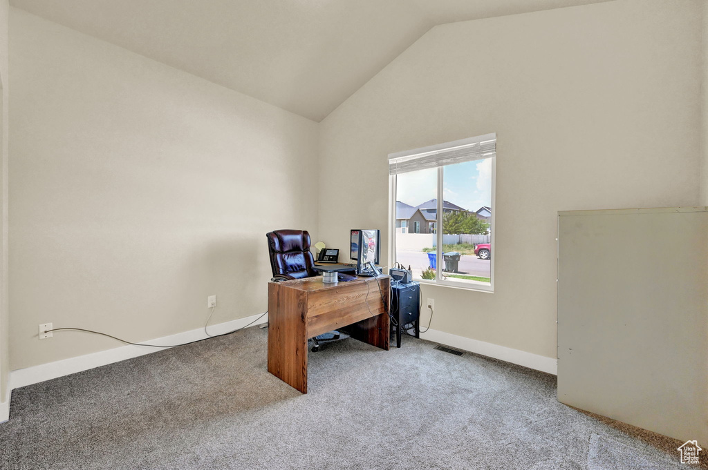 Carpeted office space with high vaulted ceiling