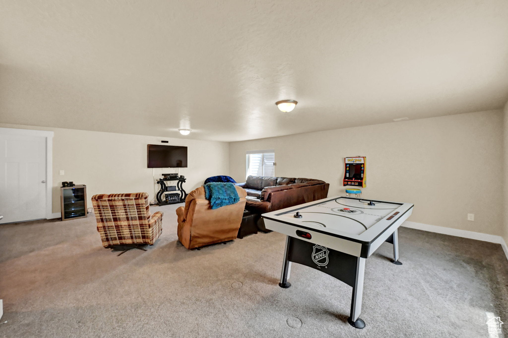 Playroom with beverage cooler and light colored carpet