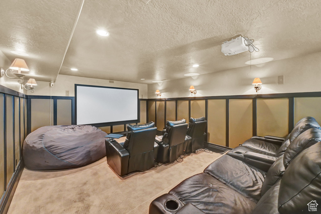 Carpeted home theater room with a textured ceiling