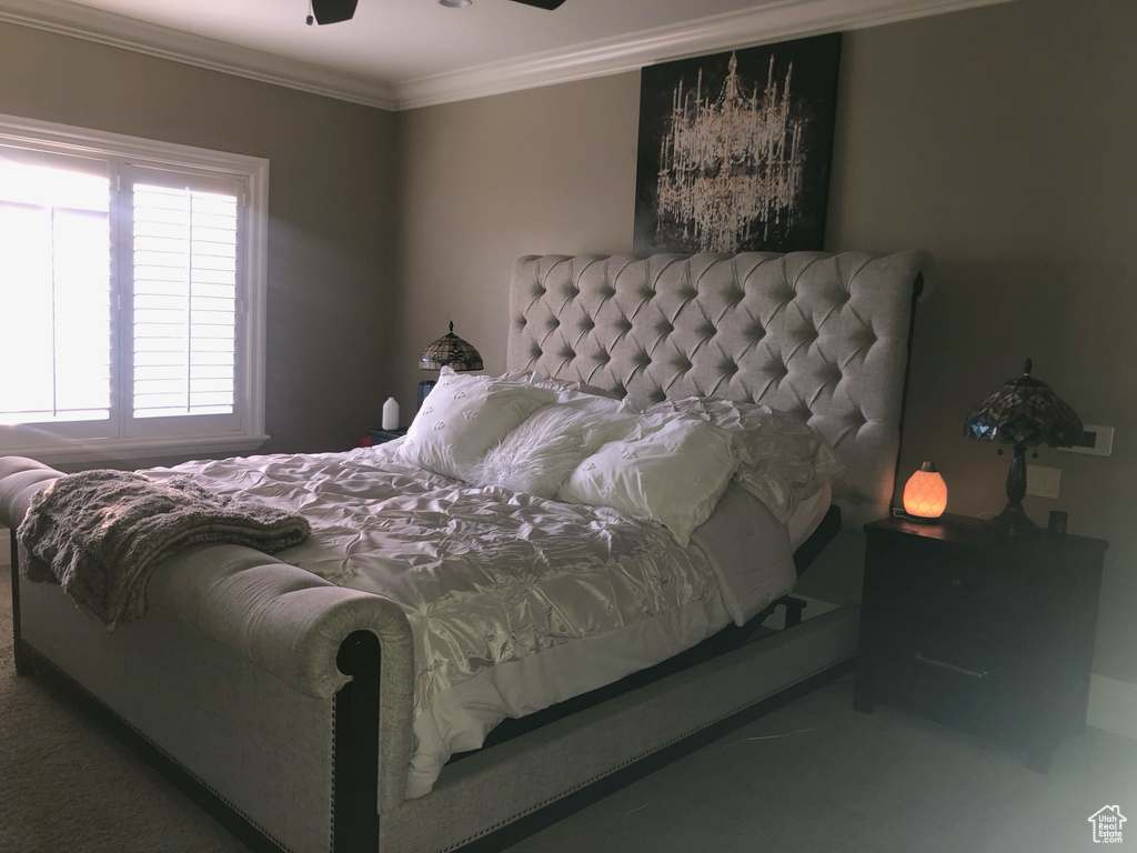 Bedroom featuring crown molding, ceiling fan, and carpet flooring