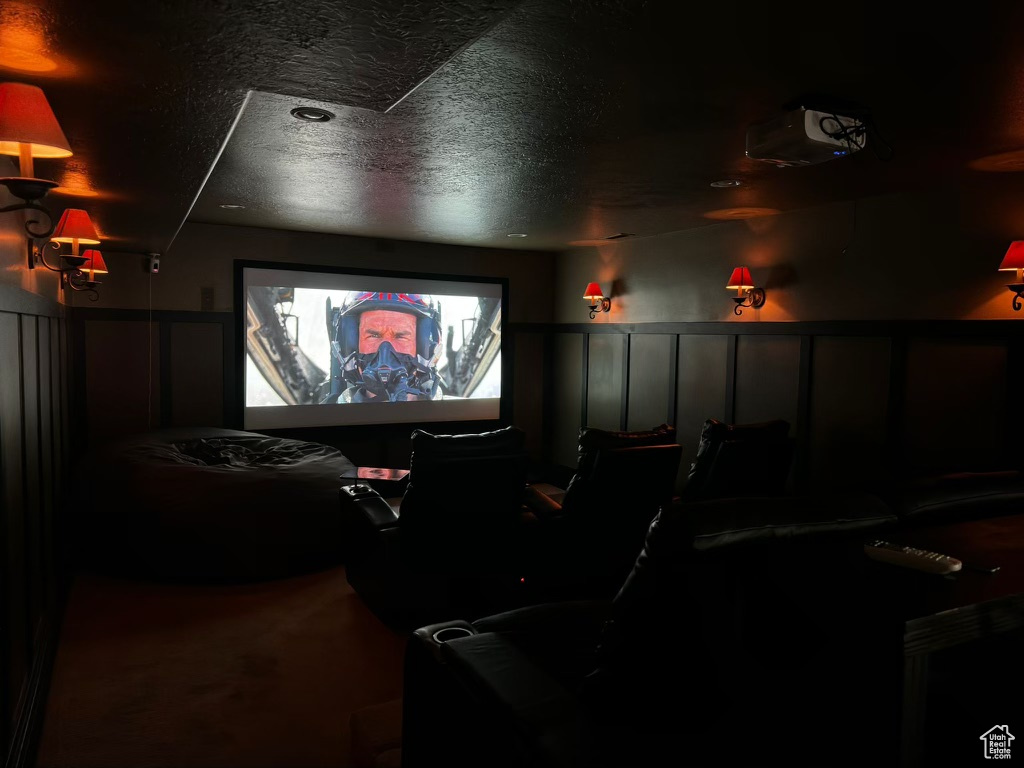 Home theater with carpet floors and a textured ceiling