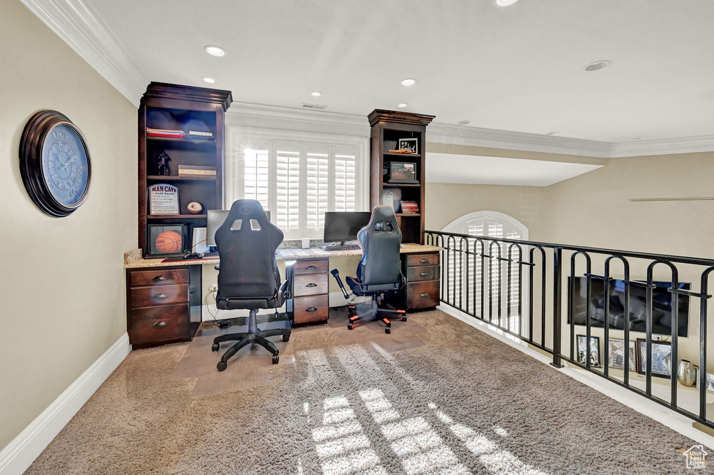 Carpeted office space featuring crown molding