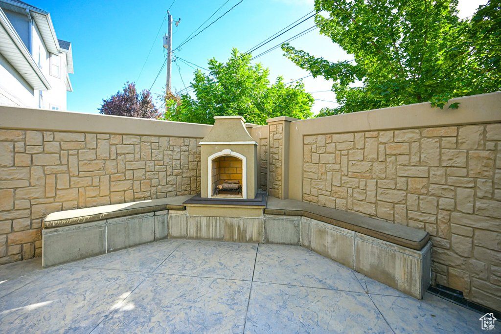 View of patio with exterior fireplace