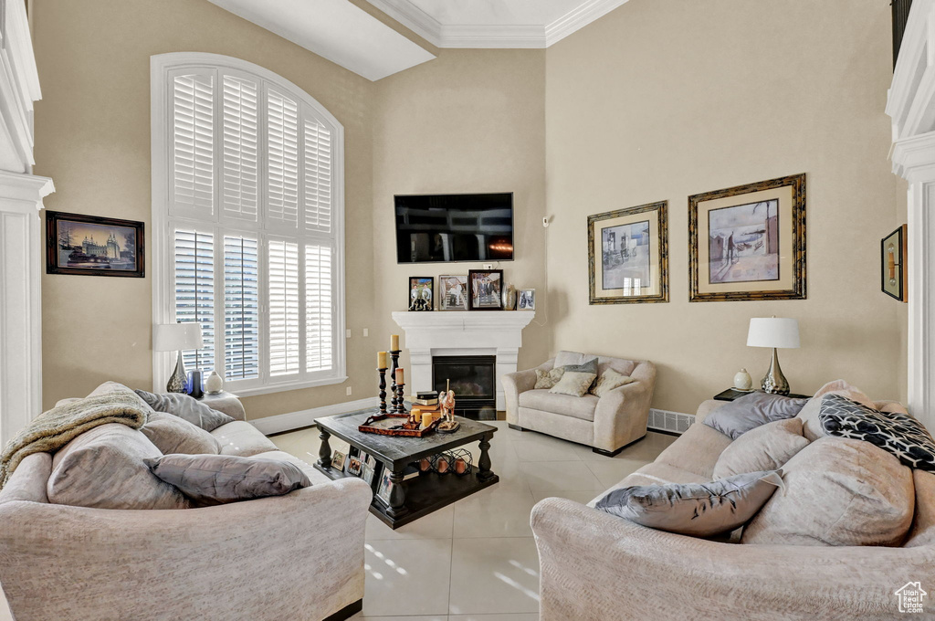 Tiled living room featuring a high ceiling